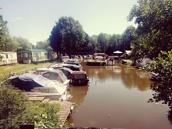 Boats moored in lake against sky