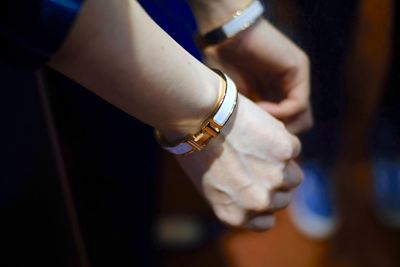 Cropped hands of woman wearing bangles