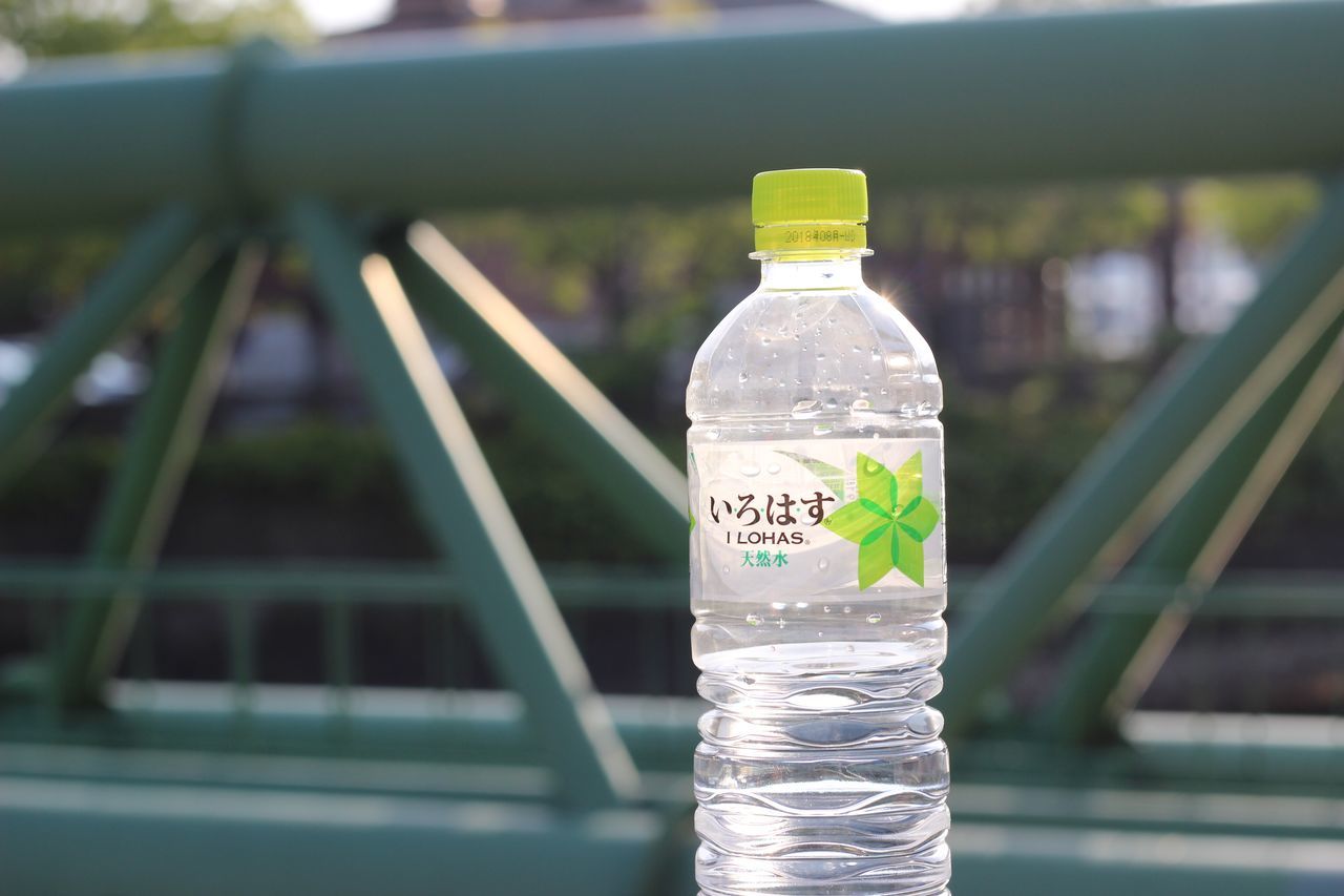 CLOSE-UP OF WATER BOTTLE ON PLASTIC