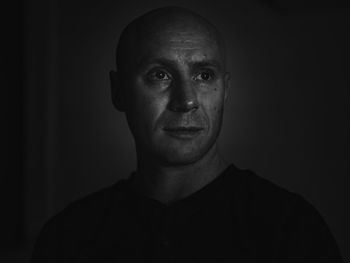 Portrait of man against black background