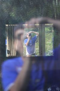 Young woman photographing through smart phone