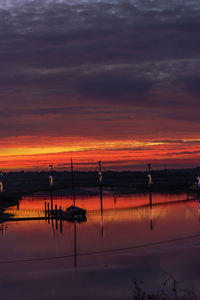 Scenic view of lake against orange sky
