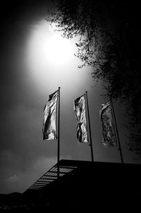 Low angle view of flags against sky