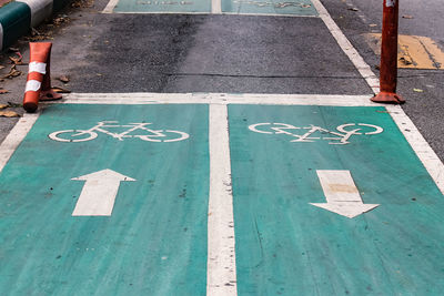 High angle view of bicycle lane sign on road