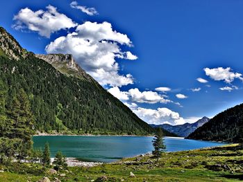 Scenic view of lake and mountains against sky