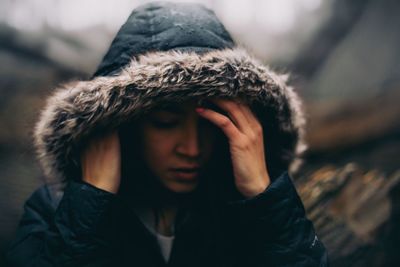 Woman wearing fur jacket during rainy season