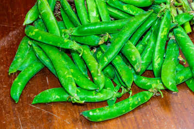 High angle view of green chili peppers on table