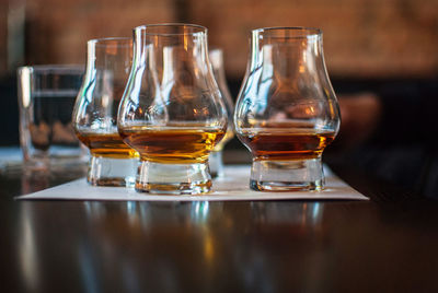 Close-up of whiskey glasses on table in bar