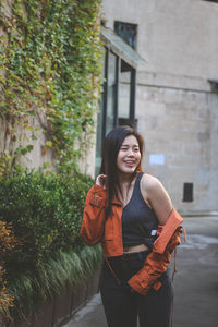 Smiling woman standing outdoors