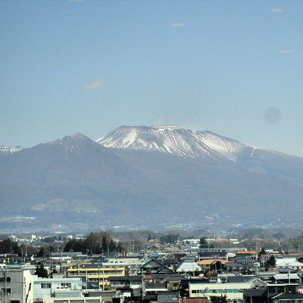 mountain, snow, winter, cold temperature, building exterior, mountain range, architecture, built structure, snowcapped mountain, season, weather, house, clear sky, scenics, covering, sky, nature, residential structure, beauty in nature, day