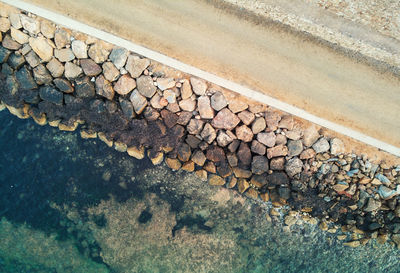 High angle view of stones by sea