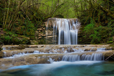 Turquoise stream front view of different waterfalls