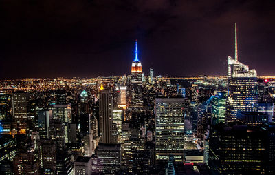 Aerial view of city lit up at night