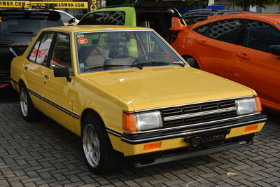 View of yellow car on street