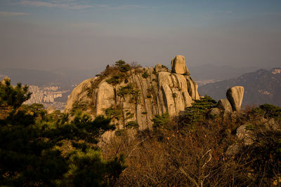 Rock formations on landscape against sky