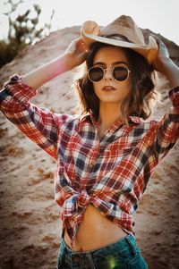 Portrait of young woman standing at beach