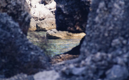 Rock formation in sea against sky