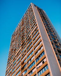 Low angle view of modern building against clear blue sky