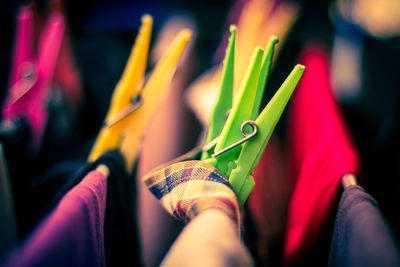 Close-up of colorful clothespins on clothesline