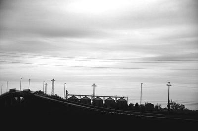 View of suspension bridge against cloudy sky