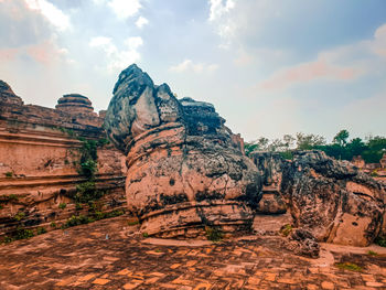 Rock formations on landscape against sky