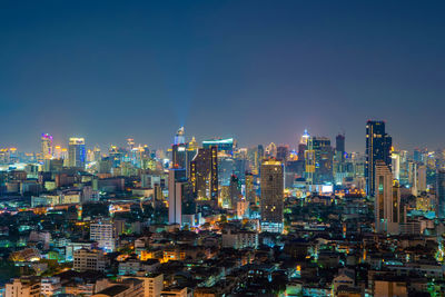 Illuminated cityscape against clear sky