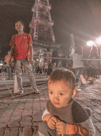 Full length portrait of boy standing at night