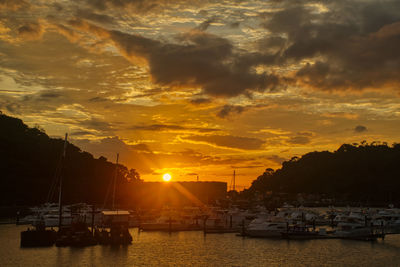 Boats in marina at sunset