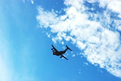 Low angle view of airplane flying in sky