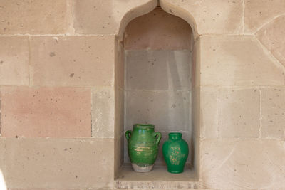 Green pots in the wall