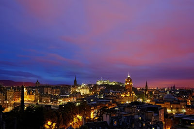 High angle view of illuminated buildings against cloudy sky