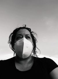 Portrait of beautiful young woman against sky