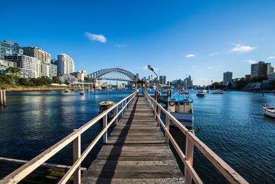 Surface level of footbridge over river and against buildings