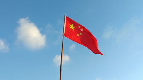 Low angle view of chinese flag against sky