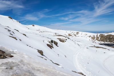 Scenic view of snow covered mountains against sky