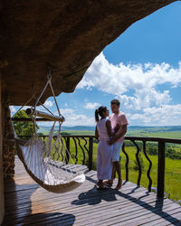 Rear view of couple standing against sea