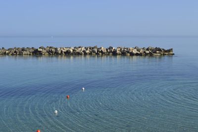 Scenic view of sea against clear blue sky