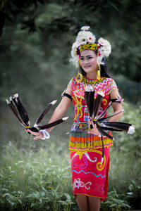 Portrait of smiling young woman holding umbrella