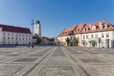 Street amidst buildings in town against clear sky