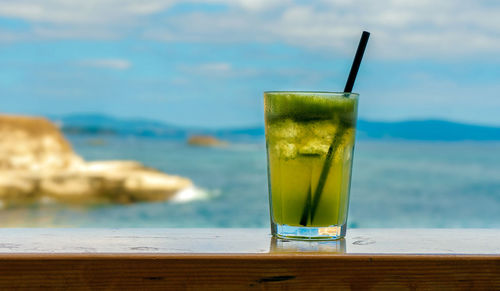 Close-up of drink on table at swimming pool