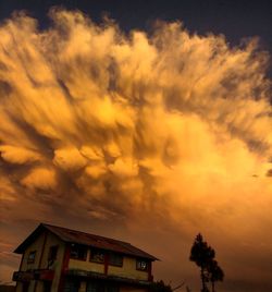 High section of built structure against cloudy sky