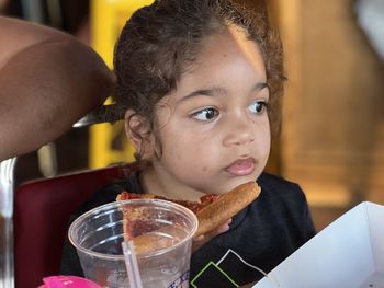 Close-up portrait of boy eating food in restaurant 