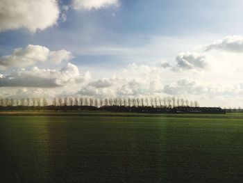 Scenic view of landscape against cloudy sky