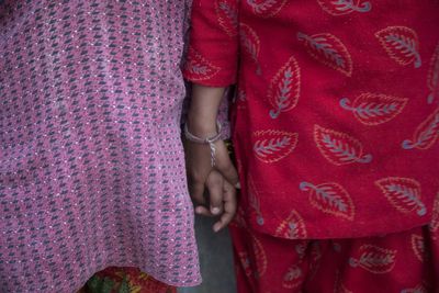 Midsection of woman with red umbrella