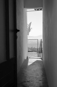 Corridor of building by sea against sky