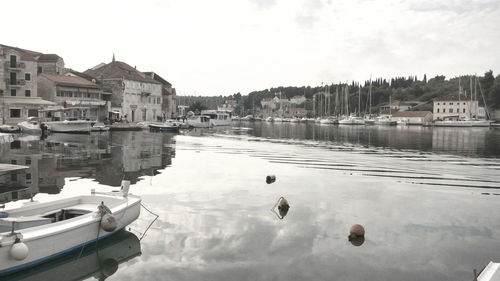 Boats in river with buildings in background