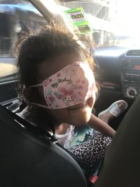 Rear view of woman sitting in car