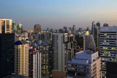 Aerial view of buildings in city against sky