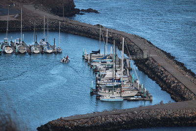 High angle view of sailboats moored at harbor