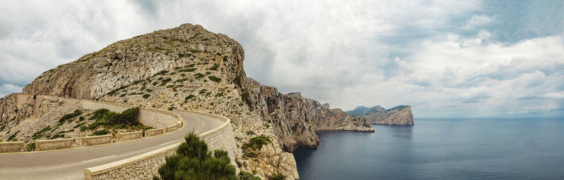 Panoramic view of sea and rock formation against sky